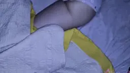 Frau liegt mit hochgeschobenem Shirt und gepunkteter Unterhose im Bett, Po wird von Männerhand fest gepackt